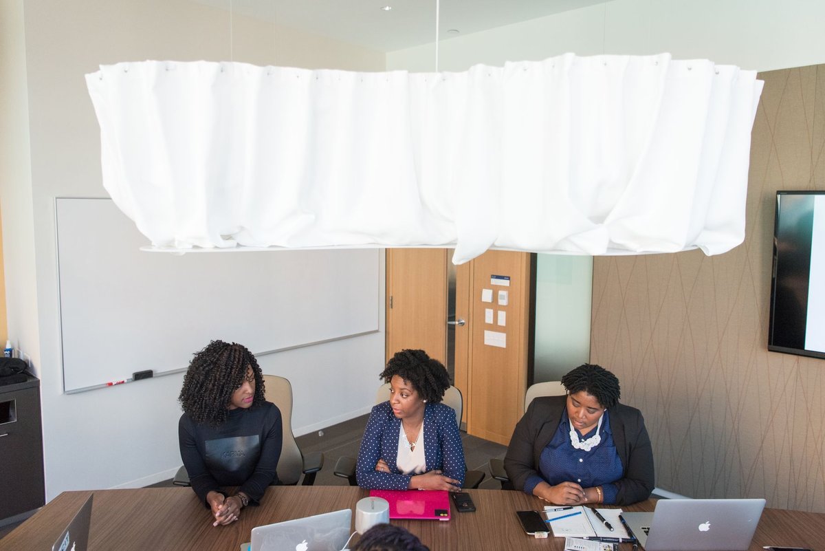 University leadership team in discussion around a meeting table