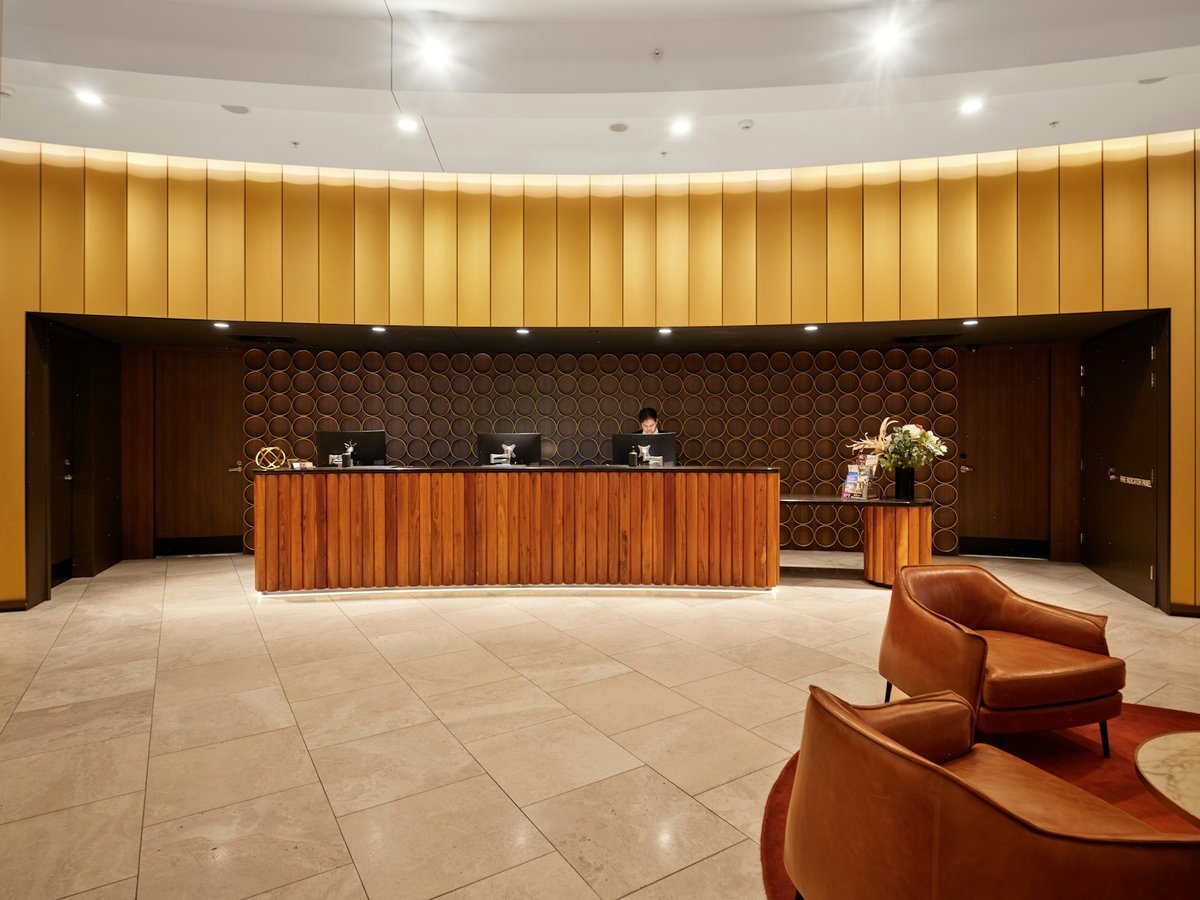 Front desk agent working at a reception workstation with two monitors