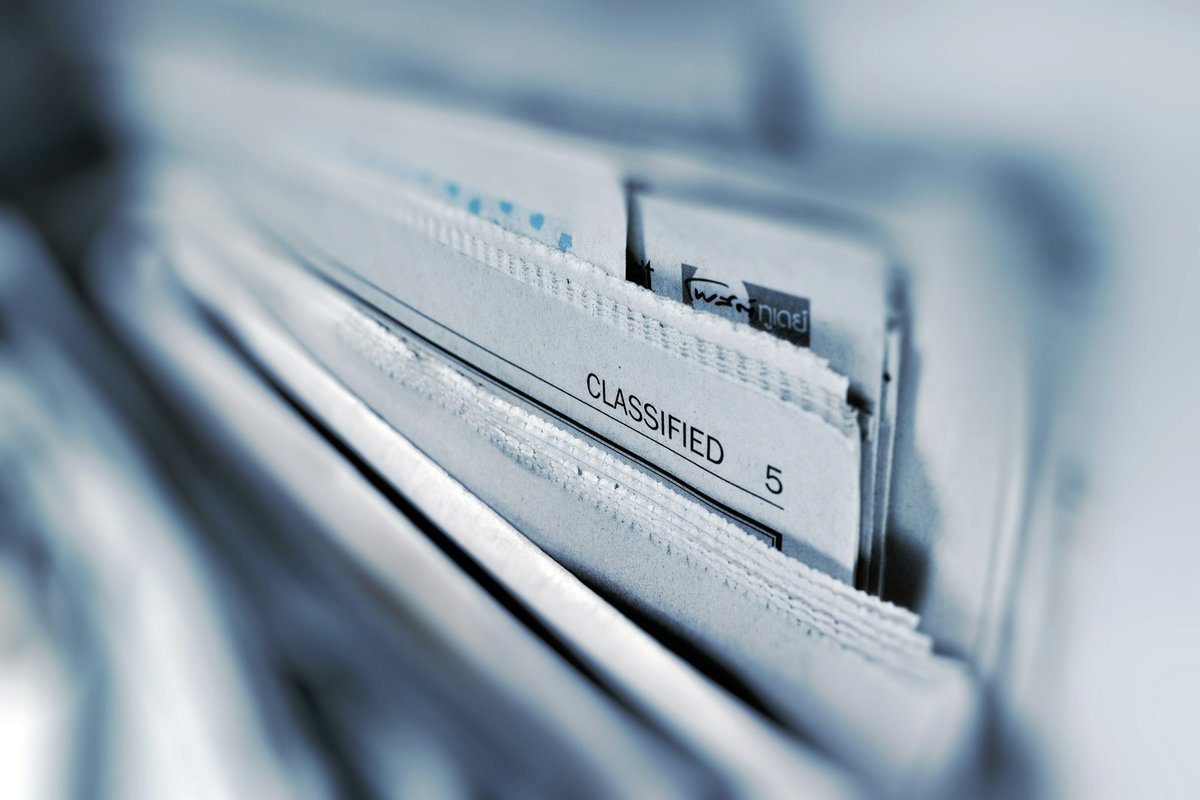 Close-up rows of labelled paper file folders in a drawer