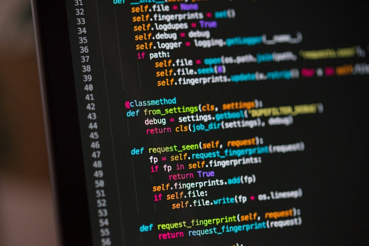 Close-up of application source code displayed on a monitor