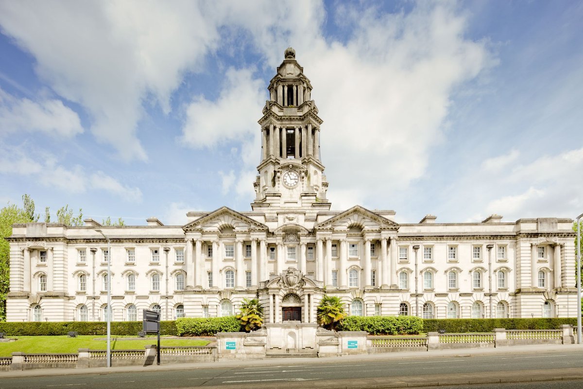 Neoclassical civic town hall building with a clock tower