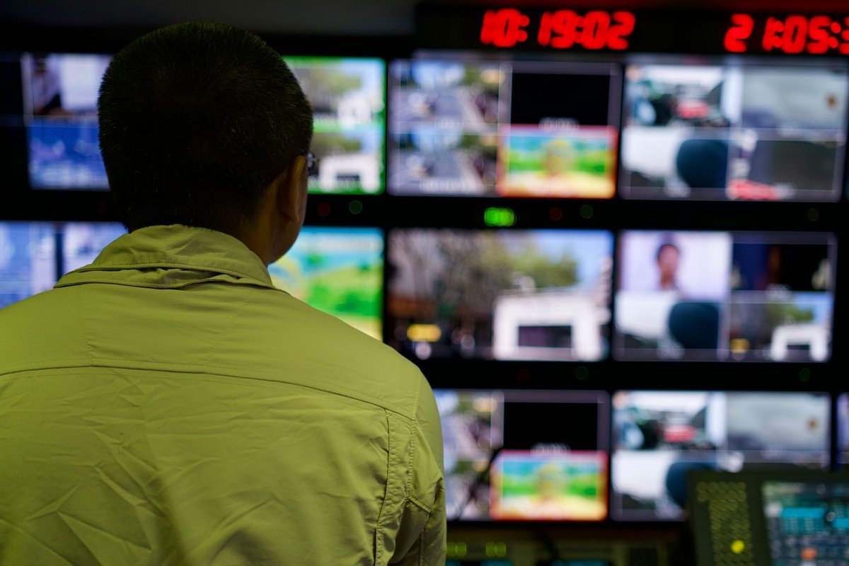 Duty manager watching a wall of security monitoring screens
