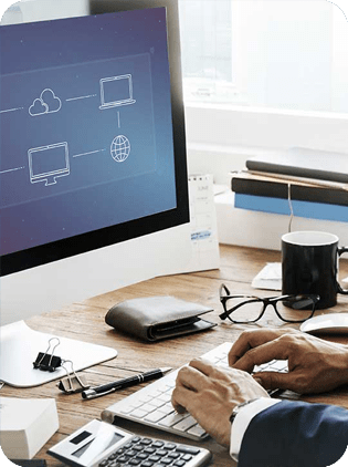 Hands typing on computer with cloud network icons.