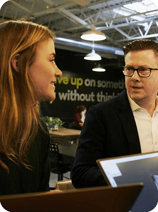 Colleagues talking in a contemporary office space.
