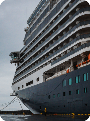 Large cruise ship docked at a pier.